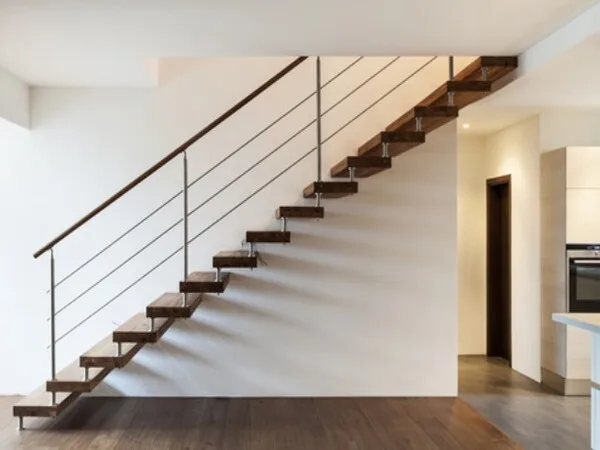 escalera minimalista con barandilla y pasamano en hierro forjado